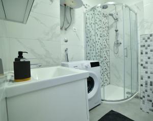 a bathroom with a washing machine and a washer at New and modern apartment BaRoNi in Split