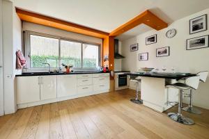 cocina con fregadero y ventana en Stylish and Bright Apartment on the Outskirts of Bordeaux, en Burdeos