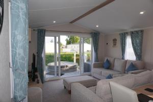 a living room with a couch and a table at Tattershall Lakes getaway in Tattershall