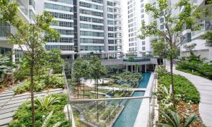 an apartment complex with a swimming pool and trees at Maxhome@Regalia suite residence. KL in Kuala Lumpur