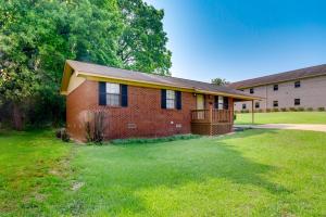 a red brick house with a large yard at Mississippi Vacation Rental Less Than 1 Mi to Ole Miss in Oxford