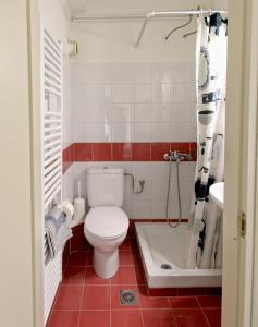 a bathroom with a white toilet and a sink at Selana Apartments in Mytilene