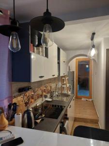 a kitchen with a sink and a stove top oven at Atraktivna kuca sa saunom i grijanim jacuzzijem in Cres