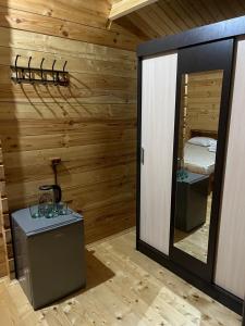 um quarto com paredes de madeira, um espelho e uma cama em Cypress House em Nova Athos