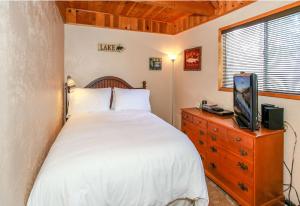 a bedroom with a bed and a tv on a dresser at Twin Bear - Cozy and convenient, relaxing cabin with a nice fenced yard and a BBQ in Sugarloaf