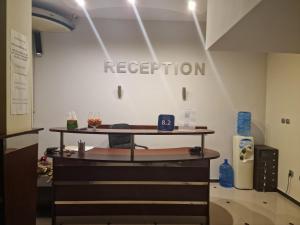a reception room with a table with a sign on the wall at hotel Harmony in Sunny Beach
