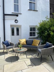 a patio with a couch and two chairs and a table at TW O Connell old world Irish pub in Cahersiveen