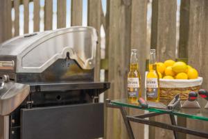 a grill with two bottles of beer and a basket of lemons at Relax in Style Near the Heart of Music City in Nashville