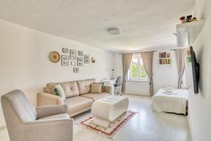 a living room with a couch and a chair at Eva's country house in Buljarica