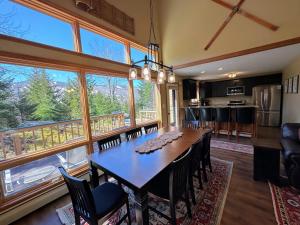 a dining room with a table and chairs and a kitchen at New Property! Updated 3 bed 3 bath condo with mountain ski slope views in Bretton Woods in Bretton Woods