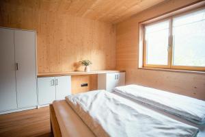 a small room with a bed and a window at Barbara's Ferienwohnungen in Au im Bregenzerwald