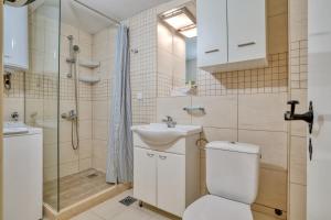a bathroom with a toilet and a sink and a shower at Eva's country house in Buljarica +12 photos