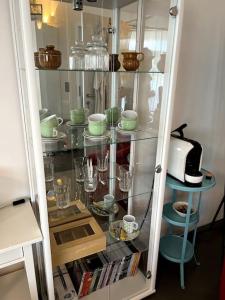 a glass cabinet filled with dishes and glasses at Haus am Hügel 