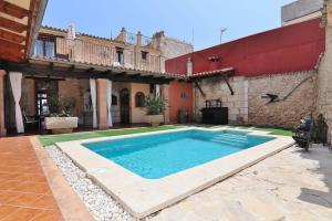 a swimming pool in the courtyard of a house at 243 Villa Can Bassa ETV3623 by Mallorca Charme in Muro
