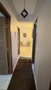 a hallway leading to a room with two doors and a table at Spacious appartement of two rooms close to morocco mall in Casablanca