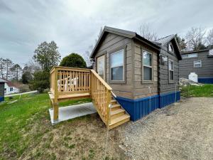 a large wooden cabin with a large deck at BMV8 Tiny Home village near Bretton Woods in Twin Mountain