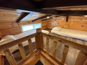 Habitación con 2 camas en una cabaña de madera en BMV8 Tiny Home village near Bretton Woods en Twin Mountain