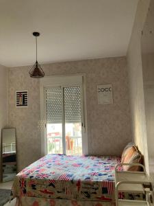 a bedroom with a bed and a window at Spacious appartement of two rooms close to morocco mall in Casablanca