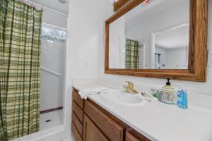 a bathroom with a sink and a mirror at Gnome Chalet - Charming Big Bear country home! Amazing craftsmanship and with a Fenced Yard! in Big Bear Lake +19 photos