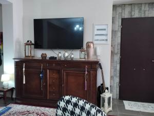 a living room with a flat screen tv on a wall at Angelo Apartment 4 karavomylos in Karavomylos