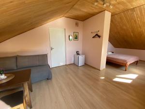 a living room with a couch and a bed at Rest in Palanga in Palanga