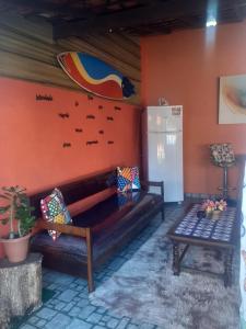 a living room with a couch and a refrigerator at Casa Azul-Paraíso em Búzios in Búzios