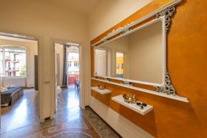 a large mirror on a wall in a room at Casa Pier - Centralissima in villa d'epoca in Rapallo +21 photos