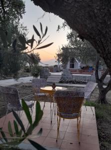 a table and chairs sitting on a patio at Sea and Garden House in Psakoudia