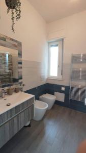 a bathroom with a sink and a toilet and a window at 44 gatti Grazioso monolocale in San Salvo