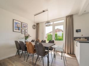 a dining room with a table and chairs at Cozy holiday home in Oploo in a wonderful environment in Oploo