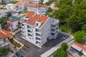 an overhead view of a white building with an orange roof at Apartman MORE Živogošće in Živogošće