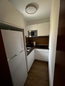 a small kitchen with a refrigerator and a microwave at El Caseto in Costa Calma