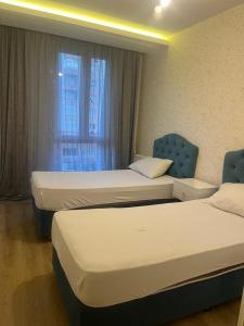 a hotel room with two beds and a window at westsid in Beylikduzu