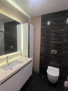 a bathroom with a white sink and a toilet at westsid in Beylikduzu