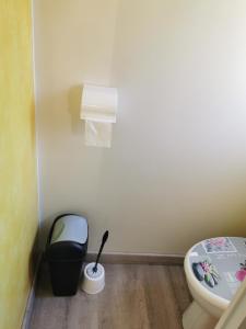 a bathroom with a toilet and a trash can at Mobil-home in Foix