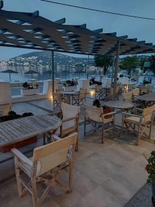 a group of tables and chairs on a patio at Alea Mare Hotel in Alinda