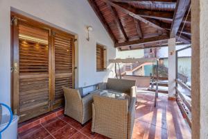 an outdoor patio with wicker chairs and a table at Vila Nikola Zlatibor in Zlatibor