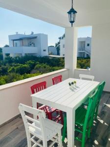 a white table and four chairs on a balcony at Rahat Ev in Bodrum City