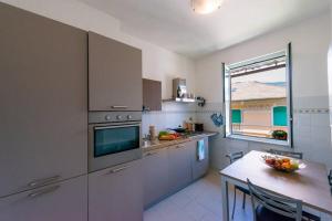 a large kitchen with a table and a window at Casa Daniele - Centralissima sul porto di Rapallo in Rapallo +18 photos