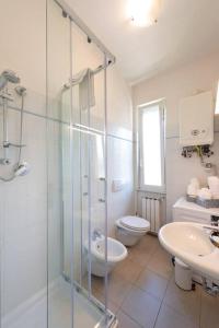 a bathroom with a shower and a toilet and a sink at Casa Daniele - Centralissima sul porto di Rapallo in Rapallo