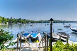 a dock with boats on a lake with a street light at Rustic Lake Retreat in Standish