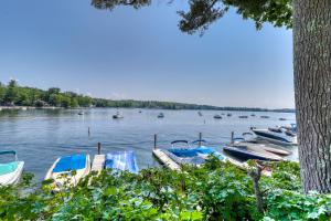 a group of boats docked at a dock on a lake at Rustic Lake Retreat in Standish