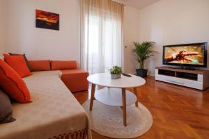 een woonkamer met een bank en een tafel bij Apartment Karmen in Šilo