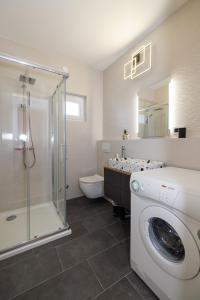 a bathroom with a washing machine and a shower at Apartment Karmen in Šilo