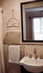 a bathroom with a sink and a mirror at Hotel Monet in Mar del Plata +29 photos