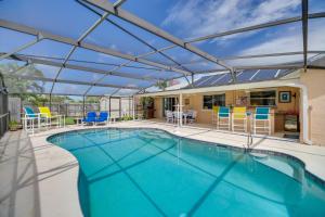 a swimming pool with a retractable roof on a patio at Waterfront Merritt Island Vacation Rental with Pool! in Merritt Island