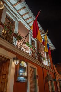 a building with two flags on a balcony at Hotel Campanario in Cuenca