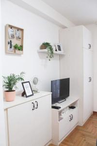 a white office with a desk with a computer on it at Apartment Atria in Vrnjačka Banja +30 photos