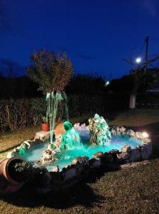 a small fountain in a yard at night at Sunny Room Lefkada in Lygia