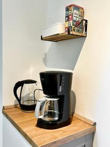 eine Kaffeemaschine auf einem Holzregal in der Unterkunft Sali - R6 - Apartmenthaus, WLAN, TV in Remscheid